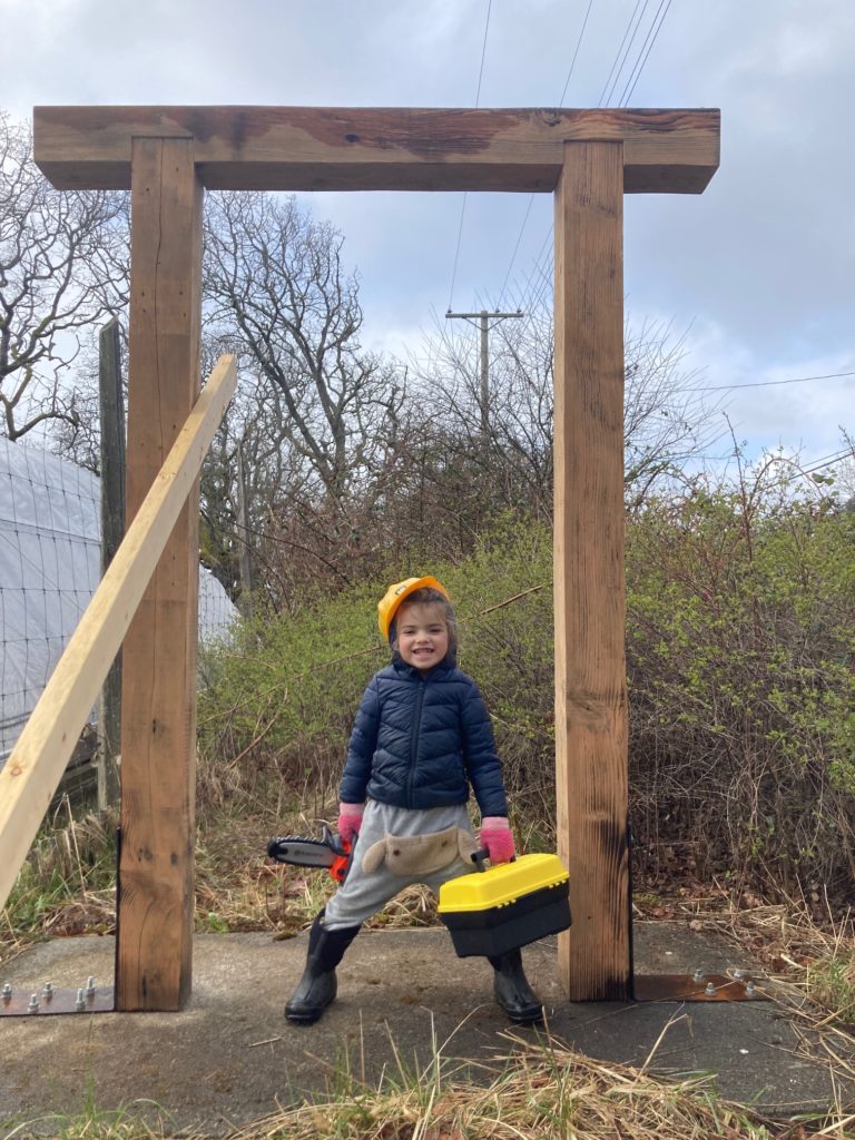 Yanou hard at work building the posts for the new farm sign.